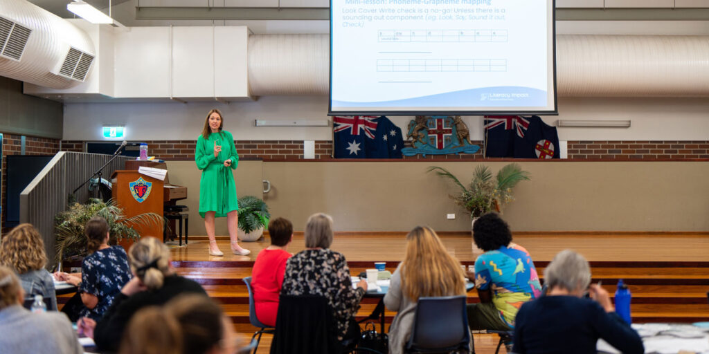 Presenter leading a literacy masterclass for a room of teachers